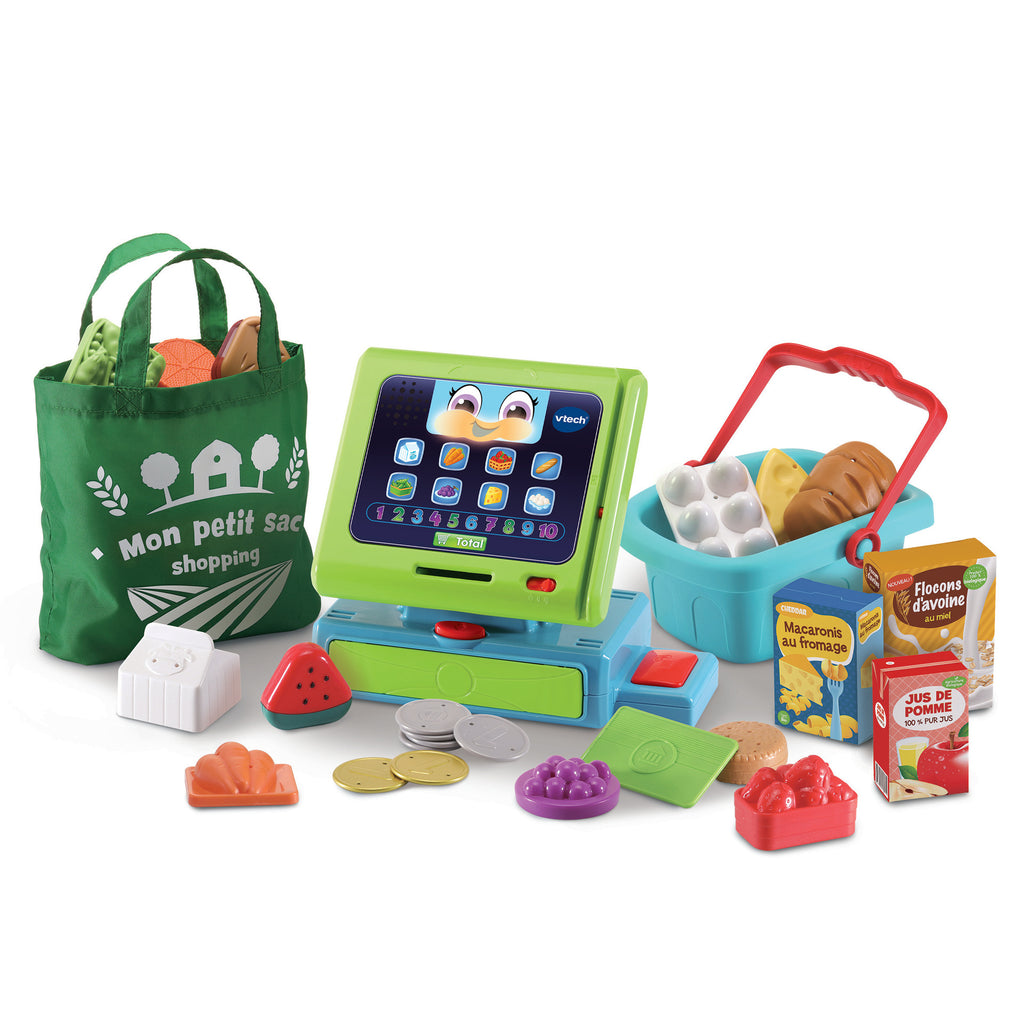 Toy cash register with groceries and a shopping bag on a white background