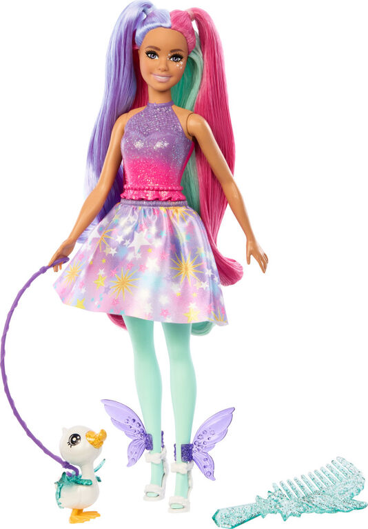 Barbie doll with colorful hair and outfit, holding a leash with a small duck-like creature, on a white background.
