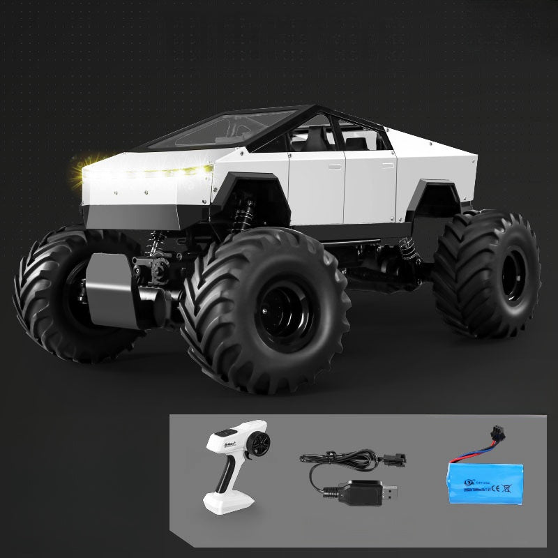 White monster truck with large black wheels on a dark background, accompanied by remote control and battery.