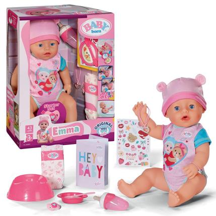 Baby doll with accessories and packaging on a white background