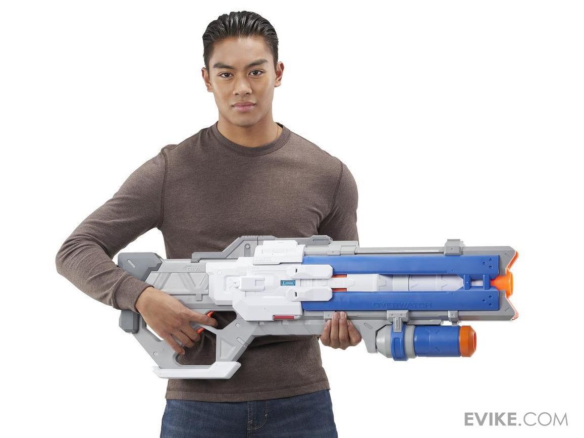 Person holding a large toy gun with nerf on a white background